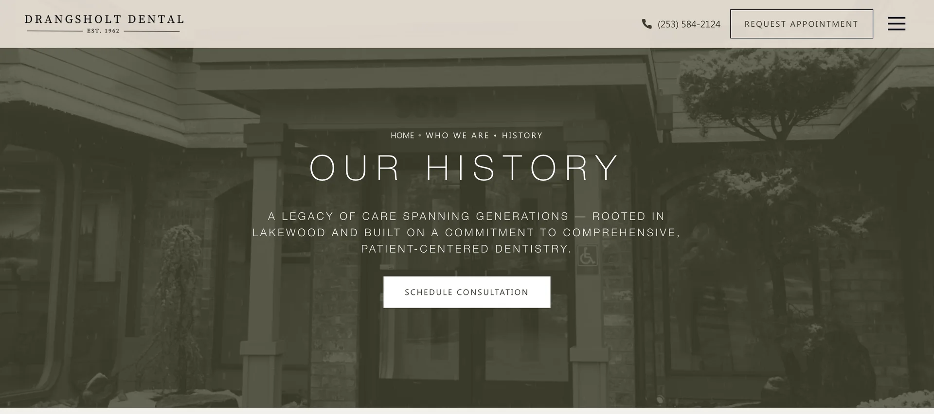 The practice history page: the office entrance in falling snow behind the words Our History